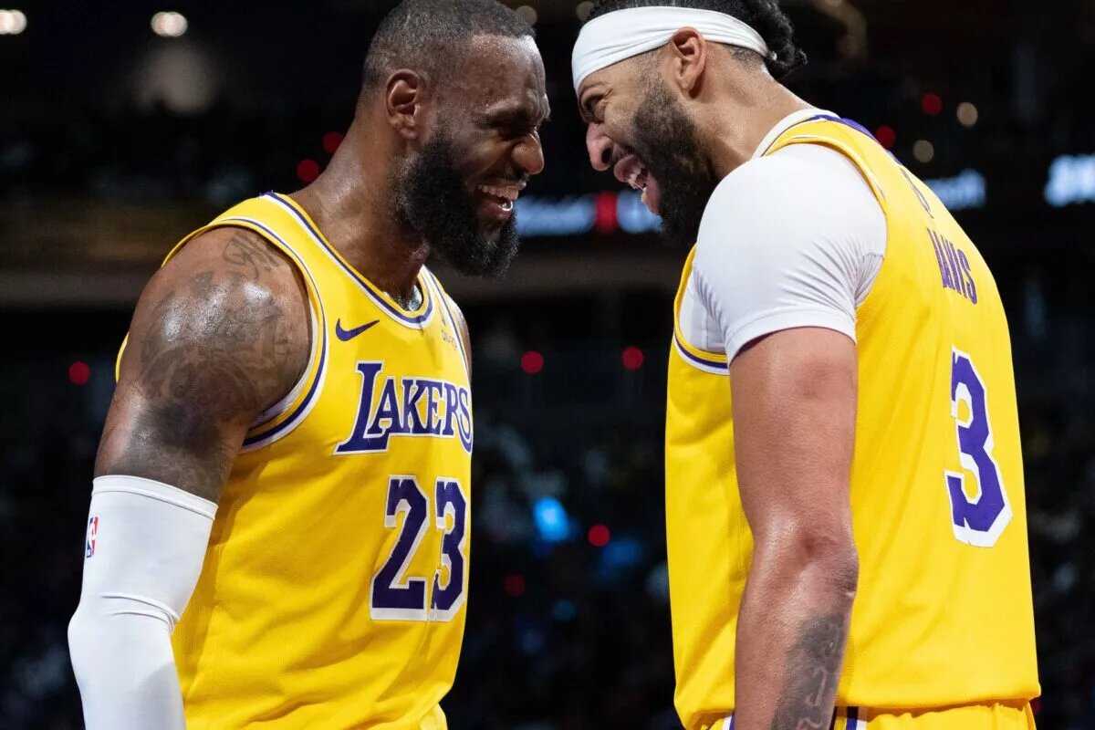 Los Angeles Lakers forward LeBron James (23) and forward Anthony Davis (3) celebrate after winning the in season tournament championship final against the Indiana Pacers at T-Mobile Arena.
