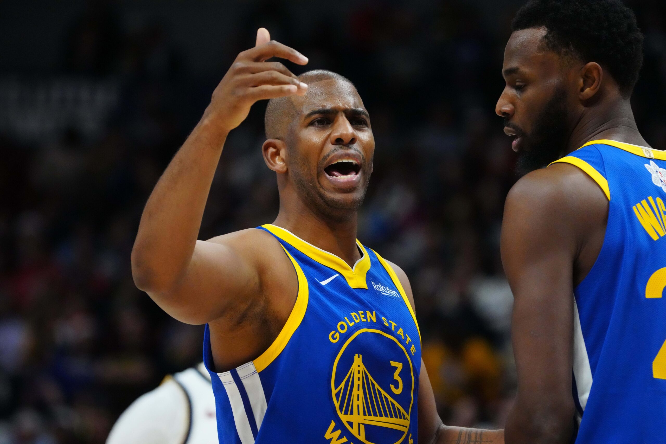 Dec 25, 2023; Denver, Colorado, USA; Golden State Warriors guard Chris Paul (3) and forward Andrew Wiggins (22) during the first half against the Denver Nuggets at Ball Arena. Mandatory Credit: Ron Chenoy-USA TODAY Sports
