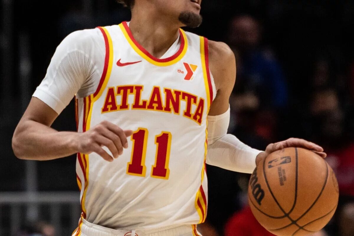 Atlanta Hawks guard Trae Young (11) dribbles the ball down the court in the game against Orlando Magic during the fourth quarter at State Farm Arena.