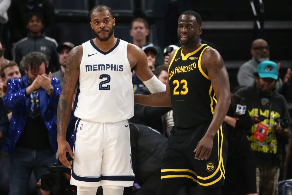 Jan 15, 2024; Memphis, Tennessee, USA; Memphis Grizzlies forward Xavier Tillman (2) and Golden State Warriors forward Draymond Green (23) embrace near the end of the second half at FedExForum. Mandatory Credit: Petre Thomas-USA TODAY Sports
