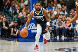 Dallas Mavericks guard Kyrie Irving (11) brings the ball up the court during the fourth quarter against the Boston Celtics at American Airlines Center.