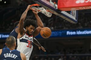 Washington Wizards forward Marvin Bagley III (35) dunks as Minnesota Timberwolves guard Anthony Edwards (5) defends during the second half at Capital One Arena.