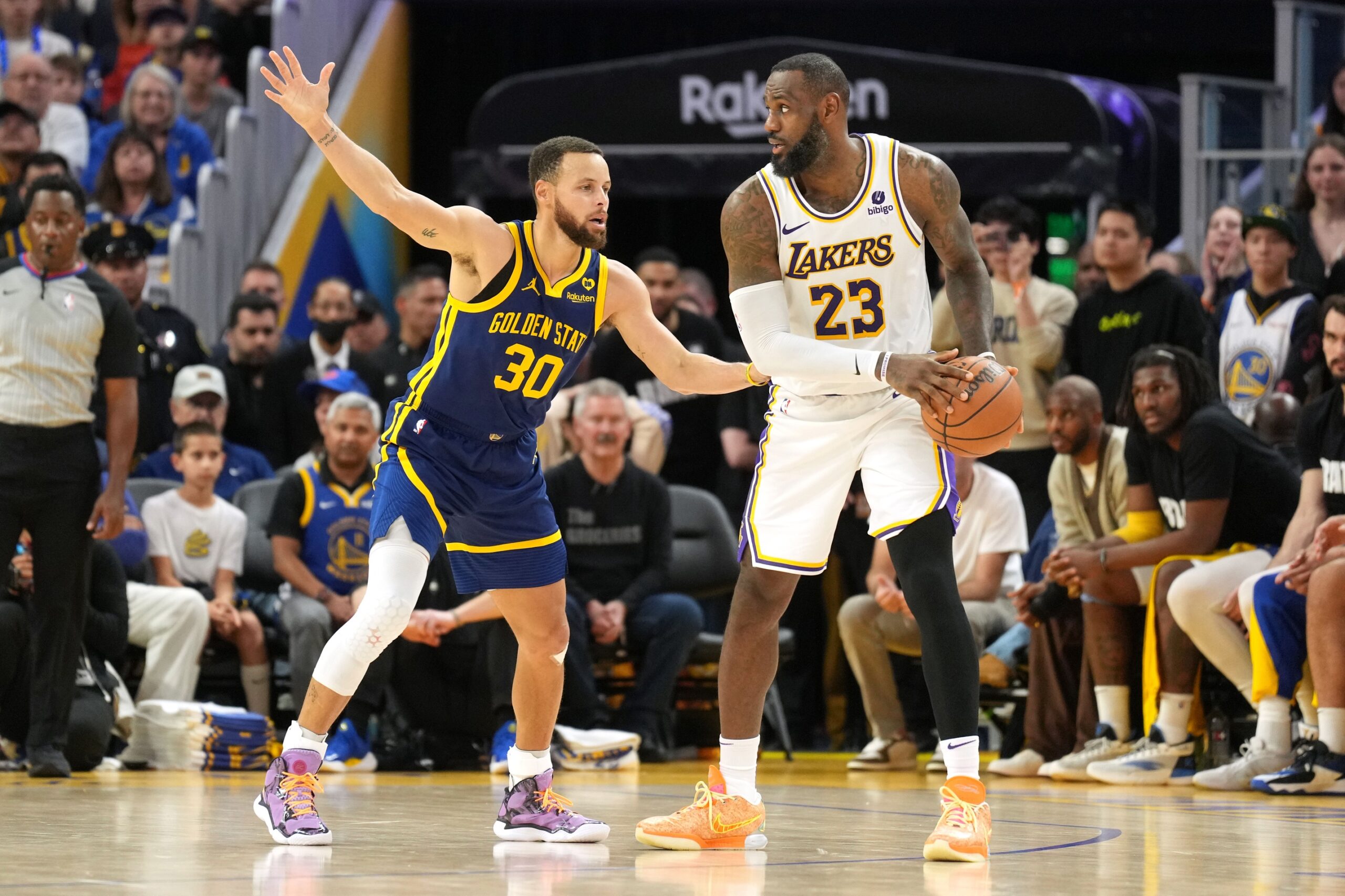 Jan 27, 2024; San Francisco, California, USA; Los Angeles Lakers forward LeBron James (23) handles the ball against Golden State Warriors guard Stephen Curry (30) during overtime at Chase Center. Mandatory Credit: Darren Yamashita-USA TODAY Sports