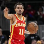 Atlanta Hawks guard Trae Young (11) points to a teammate against the Toronto Raptors during the first half at State Farm Arena.