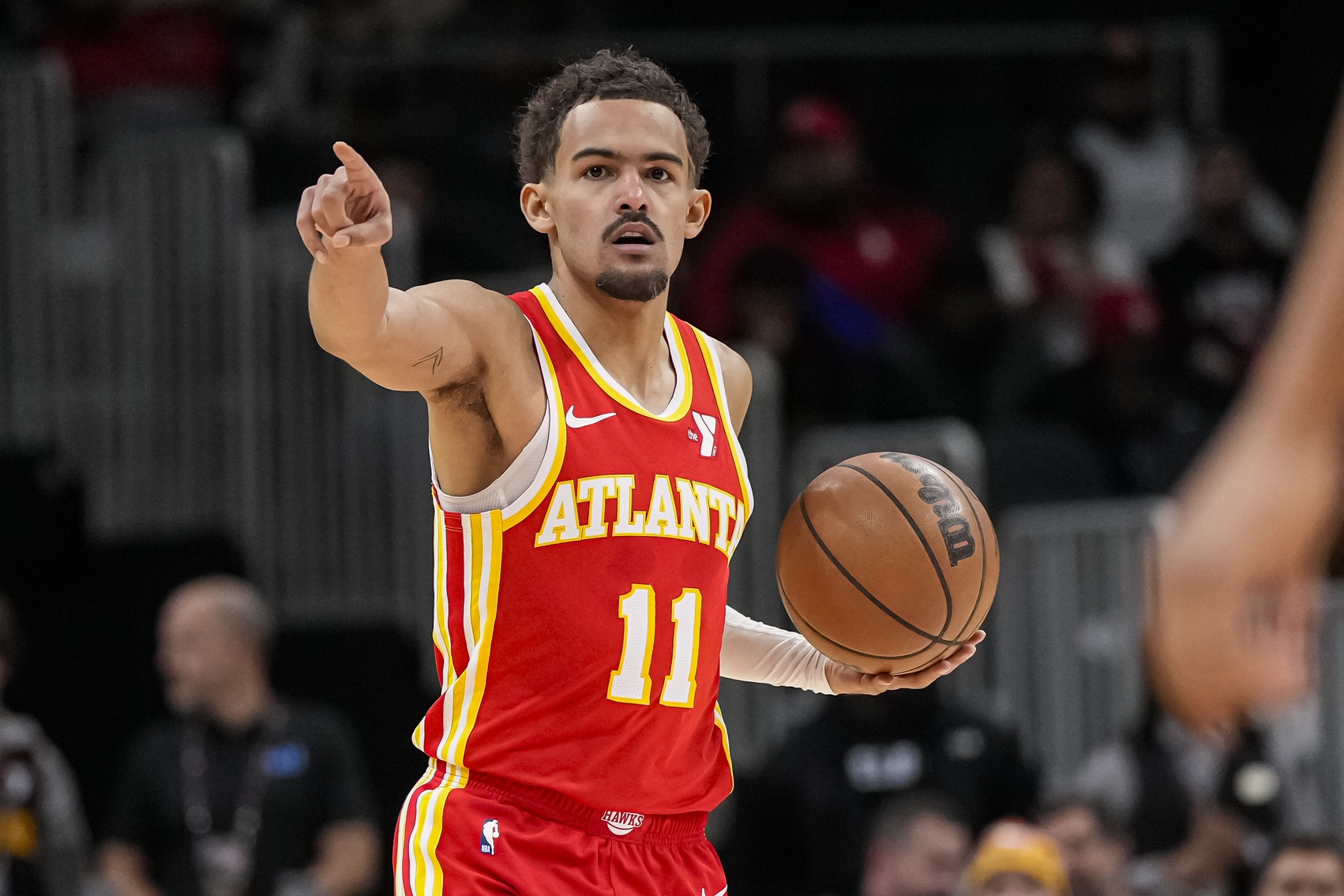 Atlanta Hawks guard Trae Young (11) points to a teammate against the Toronto Raptors during the first half at State Farm Arena.