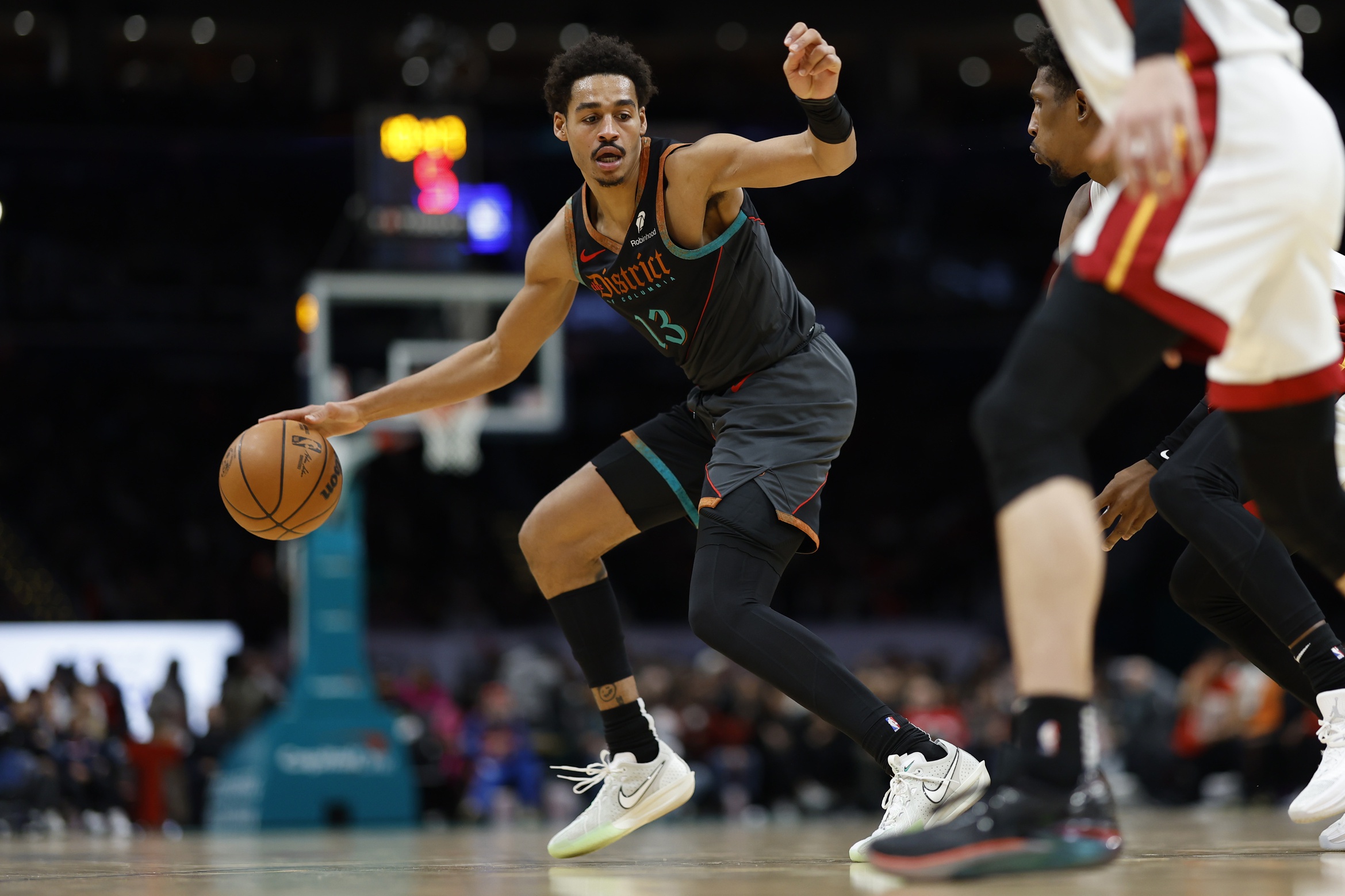 Feb 2, 2024; Washington, District of Columbia, USA; Washington Wizards guard Jordan Poole (13) drives to the basket as Miami Heat guard Josh Richardson (0) defends in the second half at Capital One Arena. Mandatory Credit: Geoff Burke-USA TODAY Sports