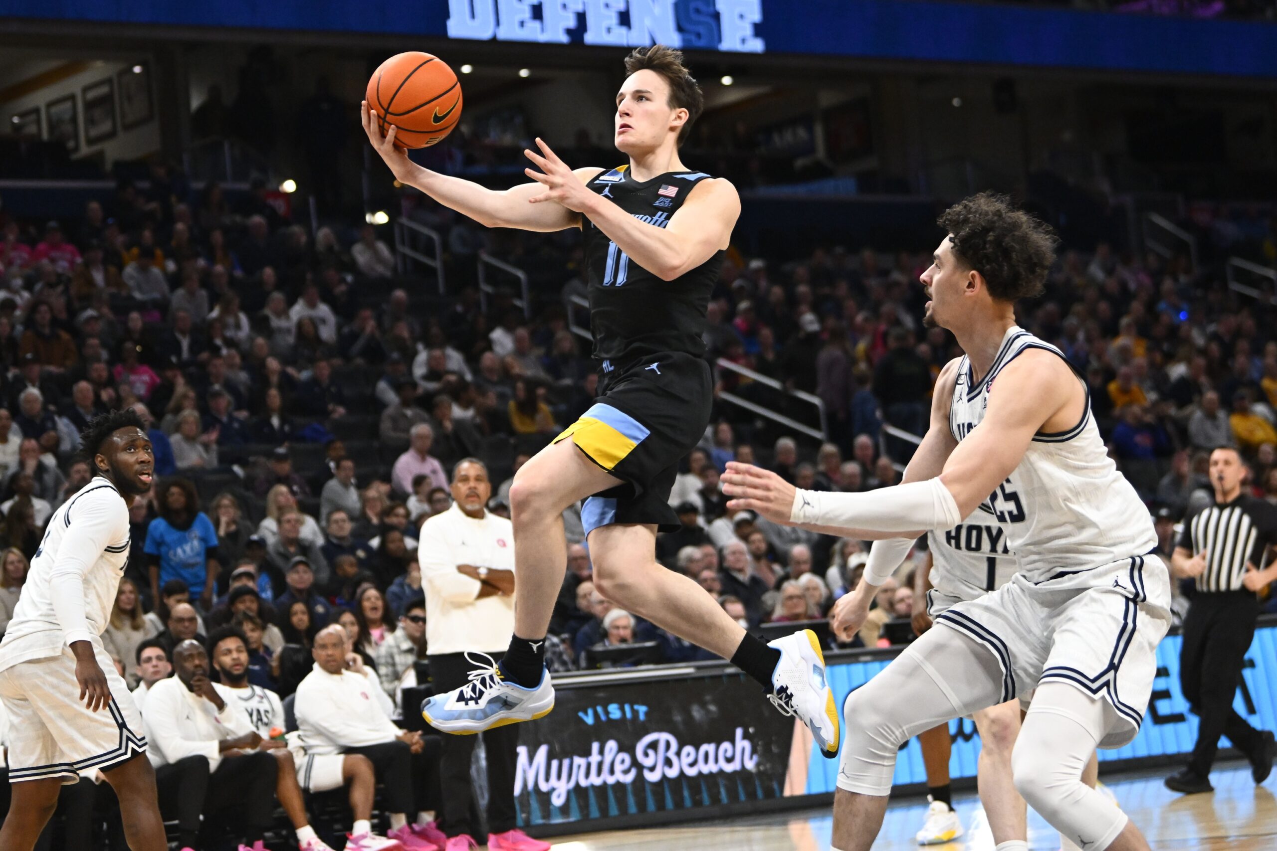 Marquette Golden Eagles guard Tyler Kolek (11) shoots past Georgetown Hoyas forward Ismael Massoud (25) during the first half at Capital One Arena.