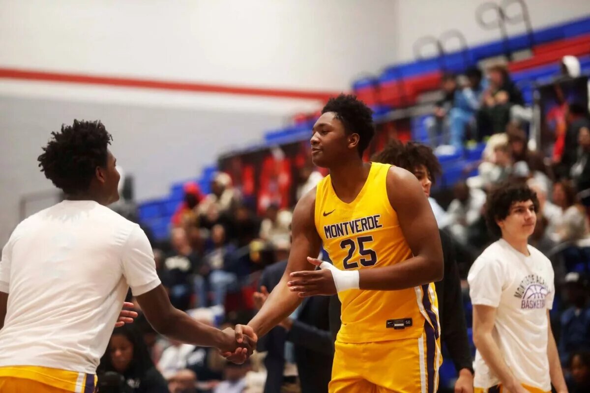 Montverde’s Derik Queen (25) shakes teammate hand during introductions against Whitehaven for a basketball game in the Winter Classic at the McDonald Insurance Arena