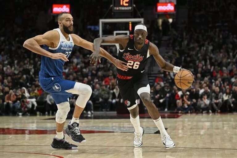 Feb 15, 2024; Portland, Oregon, USA; Portland Trail Blazers center Duop Reath (26) drives to the basket during the second half against Minnesota Timberwolves center Rudy Gobert (27) at Moda Center. Mandatory Credit: Troy Wayrynen-USA TODAY Sports