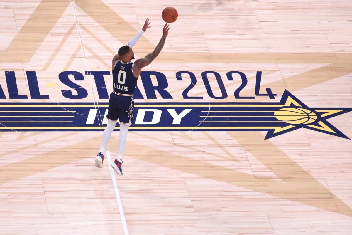 Eastern Conference guard Damian Lillard (0) of the Milwaukee Bucks makes a three point basket from half court against the Western Conference All-Stars during the fourth quarter in the 73rd NBA All Star game at Gainbridge Fieldhouse.