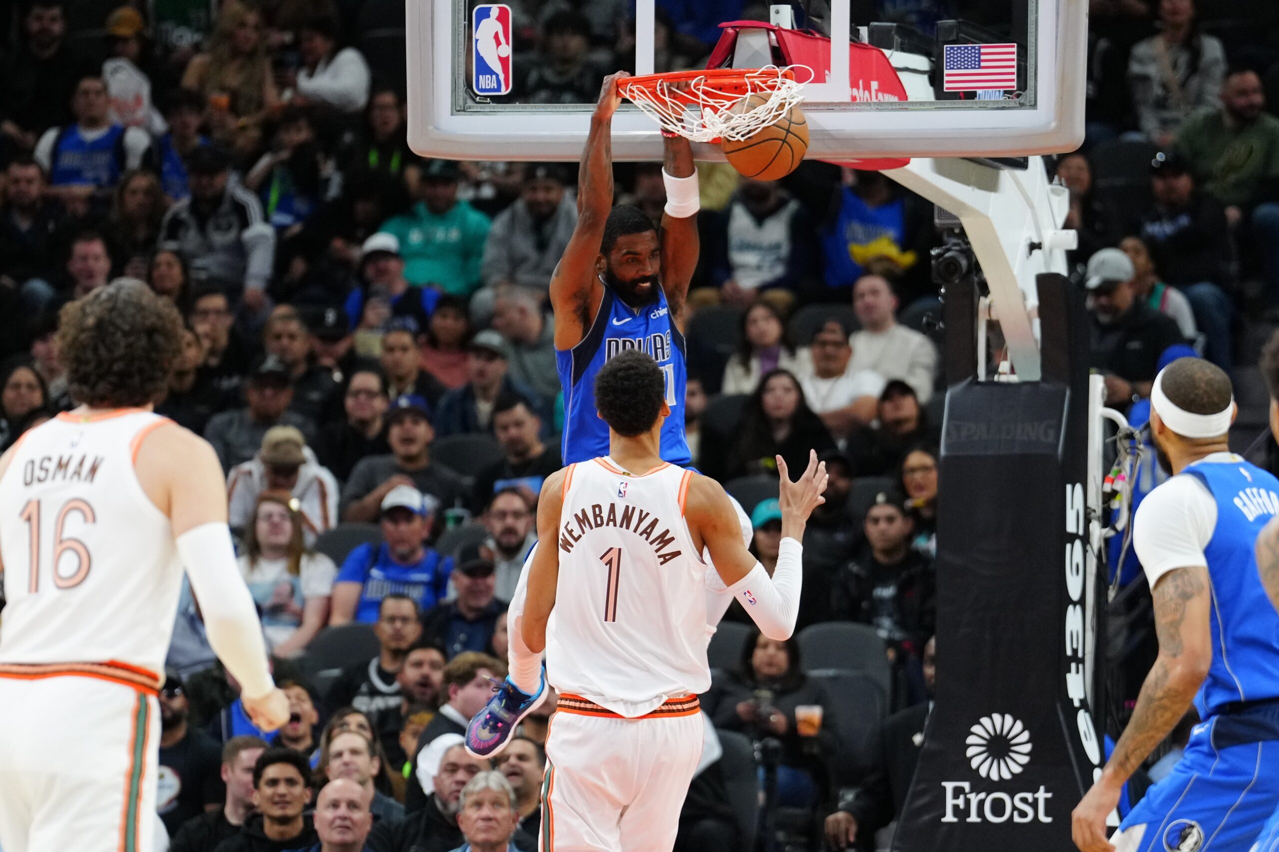 Dallas Mavericks guard Kyrie Irving dunks against Victor Wembanyama and the San Antonio Spurs