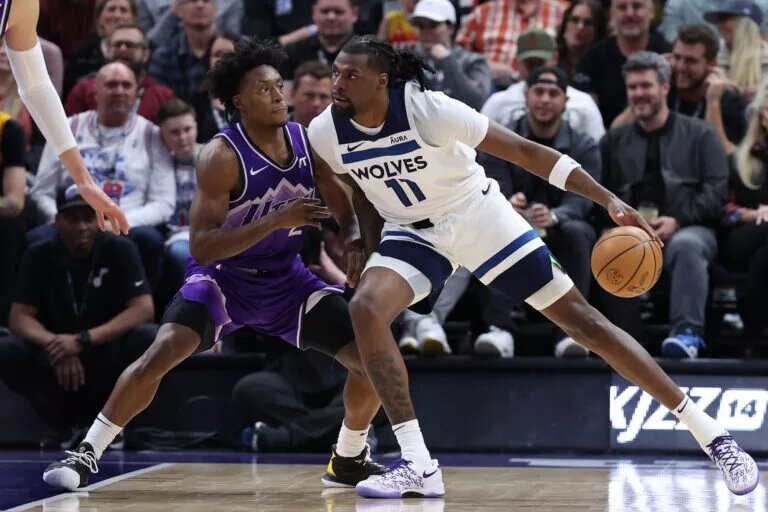 Minnesota Timberwolves big man Naz Reid attempts to score as he vies for NBA Award