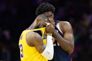 Philadelphia 76ers center Joel Embiid talks to Los Angeles Lakers forward LeBron James