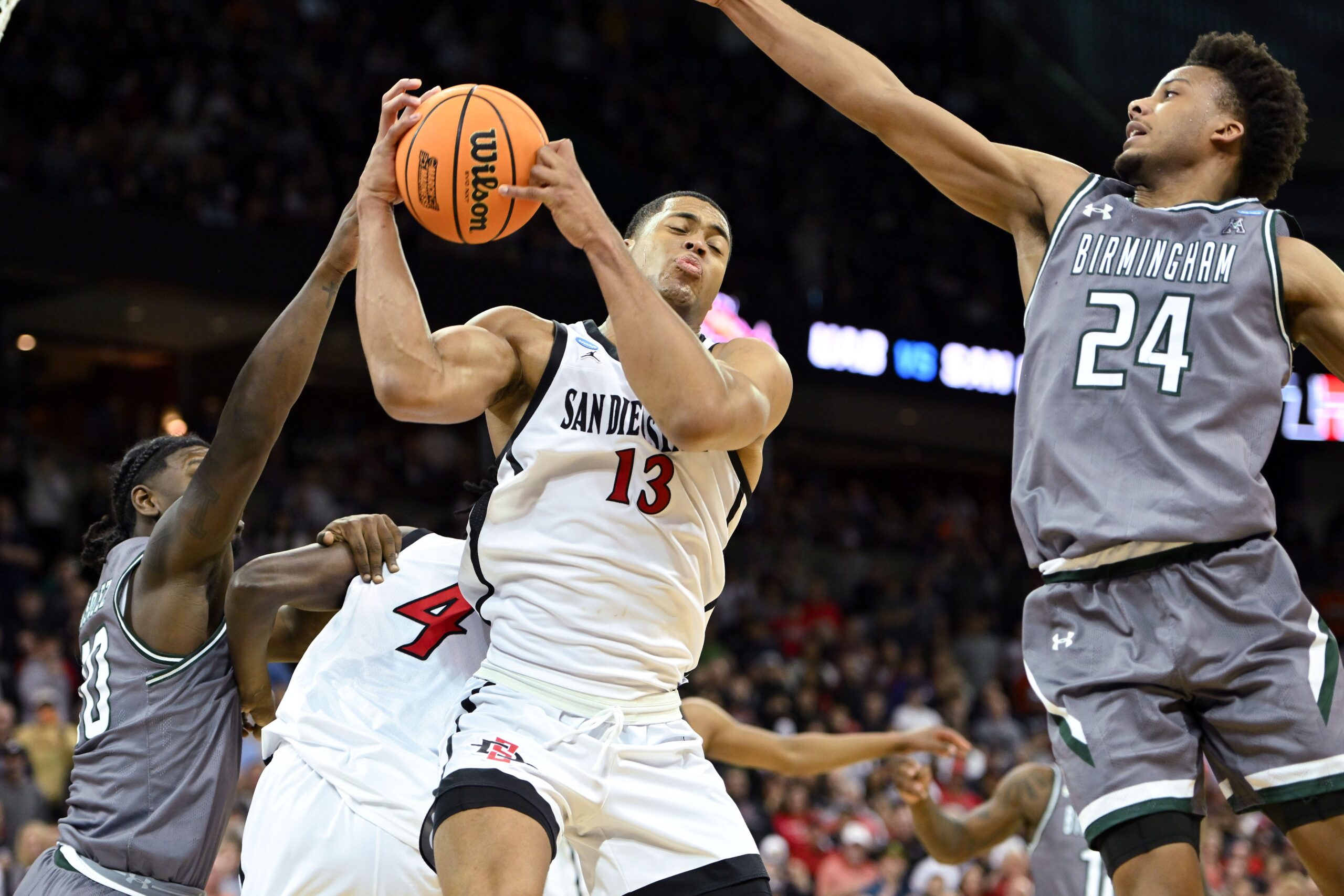 San Diego State Aztecs forward Jaedon LeDee (13) rebounds the ball against UAB Blazers guard Efrem Johnson (24) during the second half in the first round of the 2024 NCAA Tournament at Spokane Veterans Memorial Arena. Mandatory Credit: James Snook-USA TODAY Sports