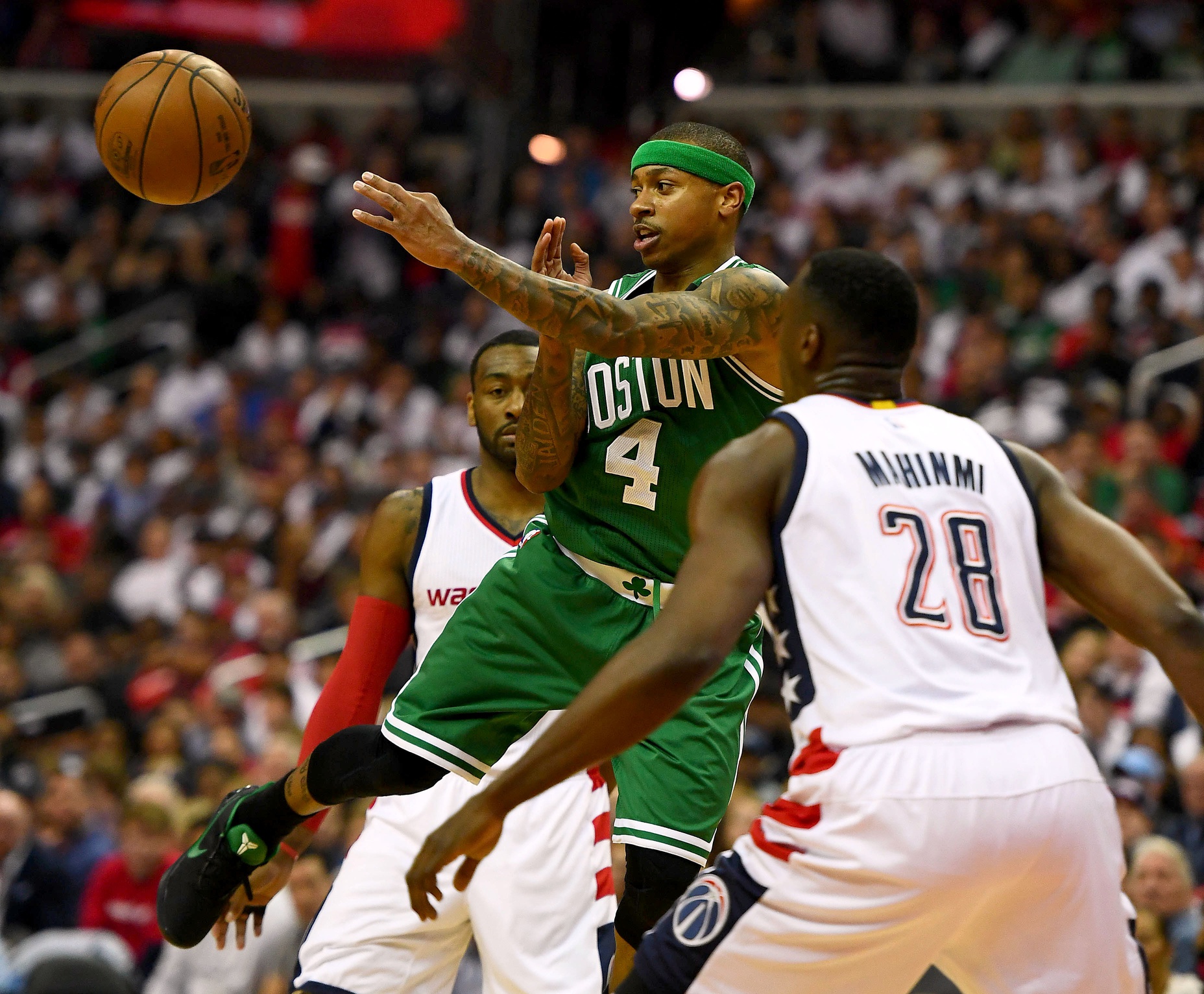 Boston Celtics guard Isaiah Thomas (4) passes the ball between Washington Wizards center Ian Mahinmi (28) and guard John Wall (2) during the second quarter in game four of the second round of the 2017 NBA Playoffs at Verizon Center.