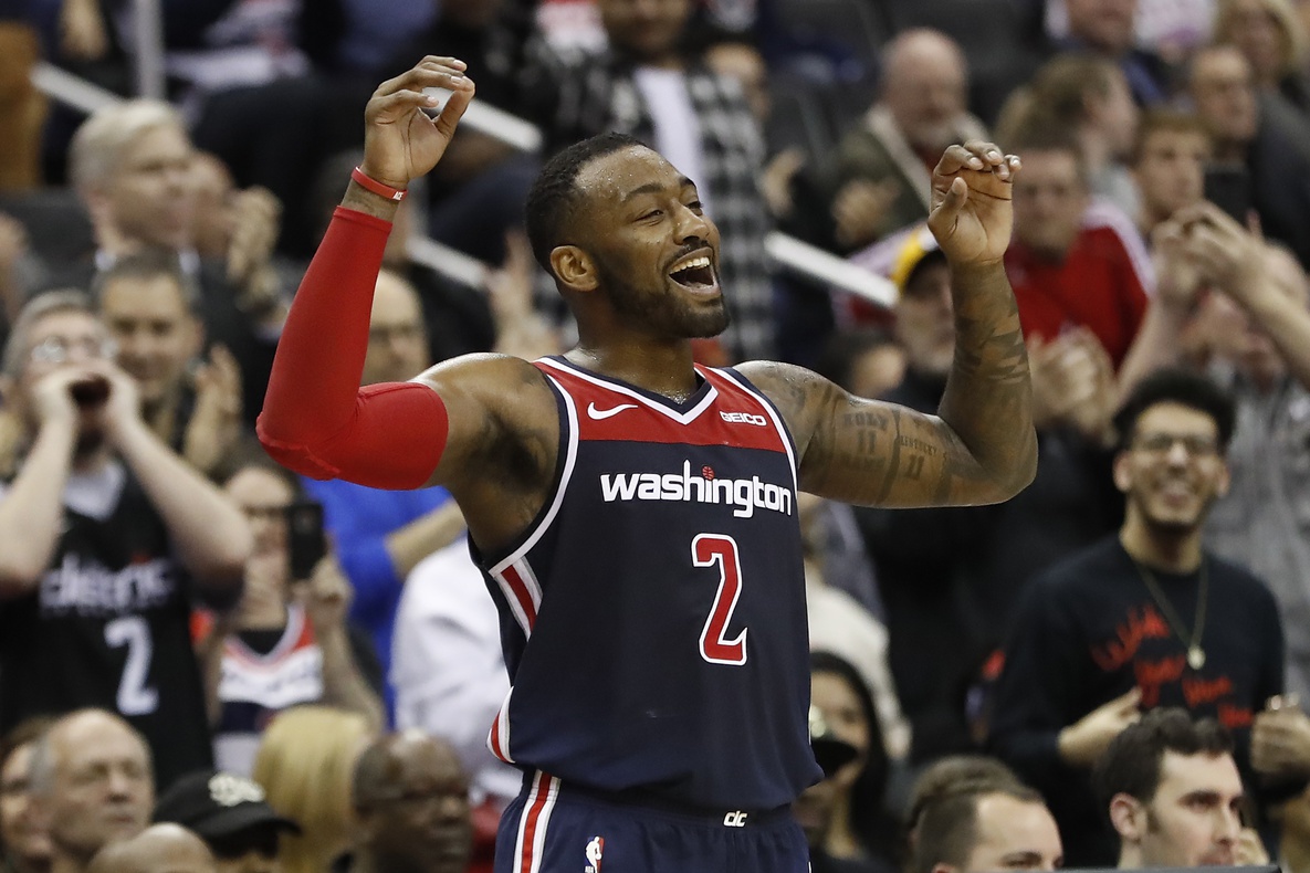 Washington Wizards guard John Wall (2) celebrates on the bench against the Los Angeles Lakers in the fourth quarter at Capital One Arena. The Wizards won 128-110.