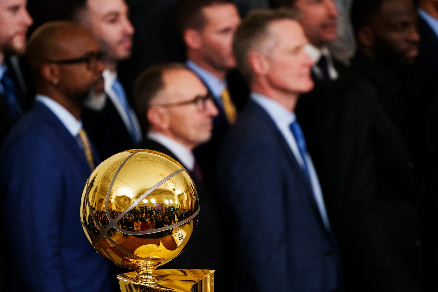 Jan 17, 2023; Washington, DC, USA; Players and staff of the Golden State Warriors stand behind the 2022 NBA championship trophy during a ceremony in the East Room at The White House. Mandatory Credit: Josh Morgan-USA TODAY