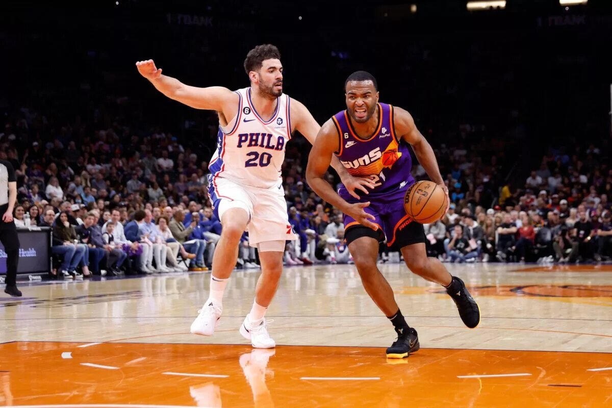 Mar 25, 2023; Phoenix, Arizona, USA; Phoenix Suns forward T.J. Warren (21) dribbles past Philadelphia 76ers forward Georges Niang (20) during the game at Footprint Center. Mandatory Credit: Chris Coduto-USA TODAY Sports