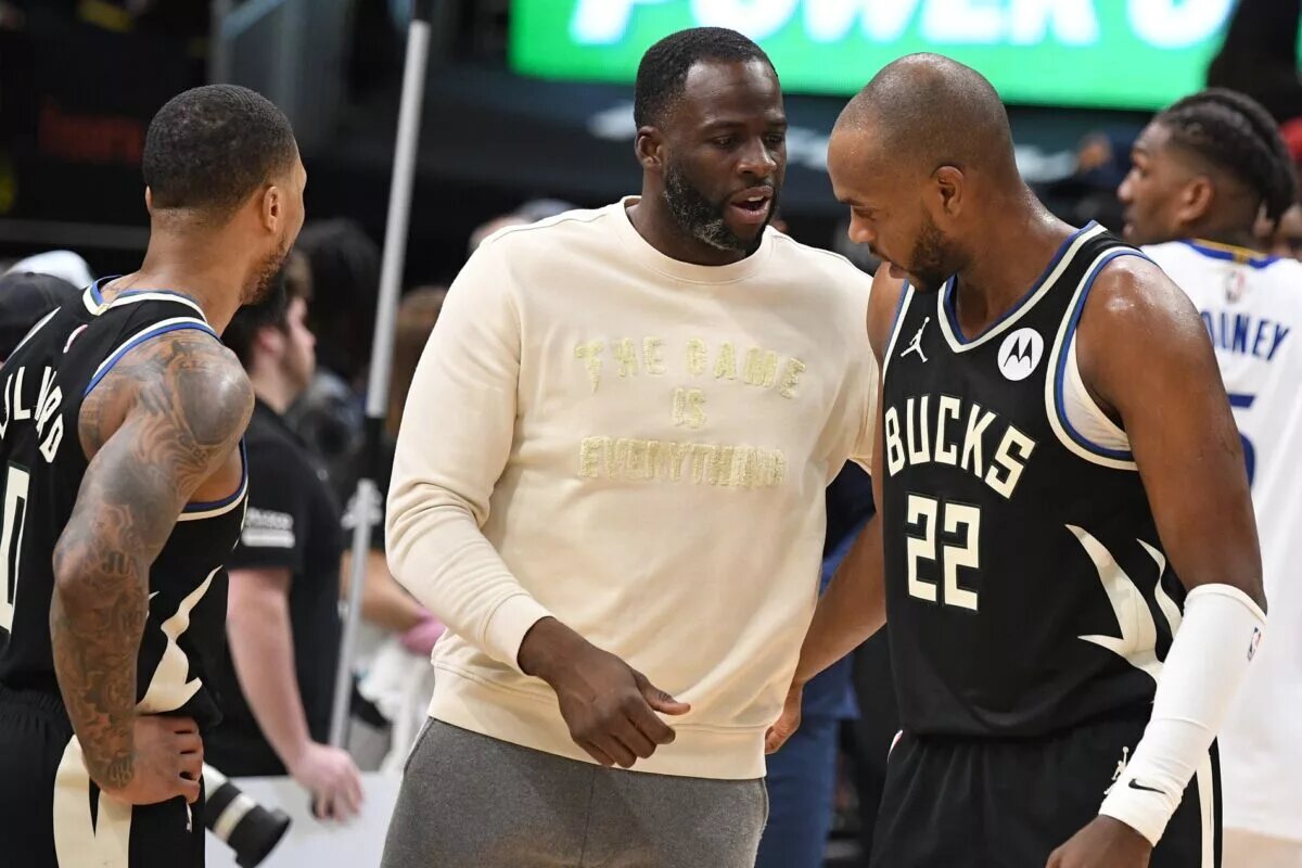 Khris Middleton of the Milwaukee Bucks with teammate Damian Lillard and Golden State Warriors forward Draymond Green