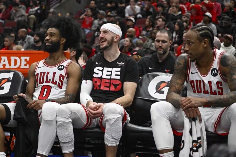 Coby White, Alex Caruso, and DeMar DeRozan of the Chicago Bulls
