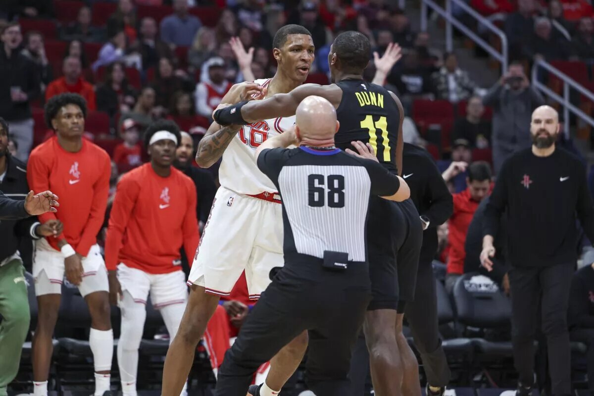Jan 20, 2024; Houston, Texas, USA; Houston Rockets forward Jabari Smith Jr. (10) and Utah Jazz guard Kris Dunn (11) exchange words during the third quarter at Toyota Center. Mandatory Credit: Troy Taormina-USA TODAY Sports