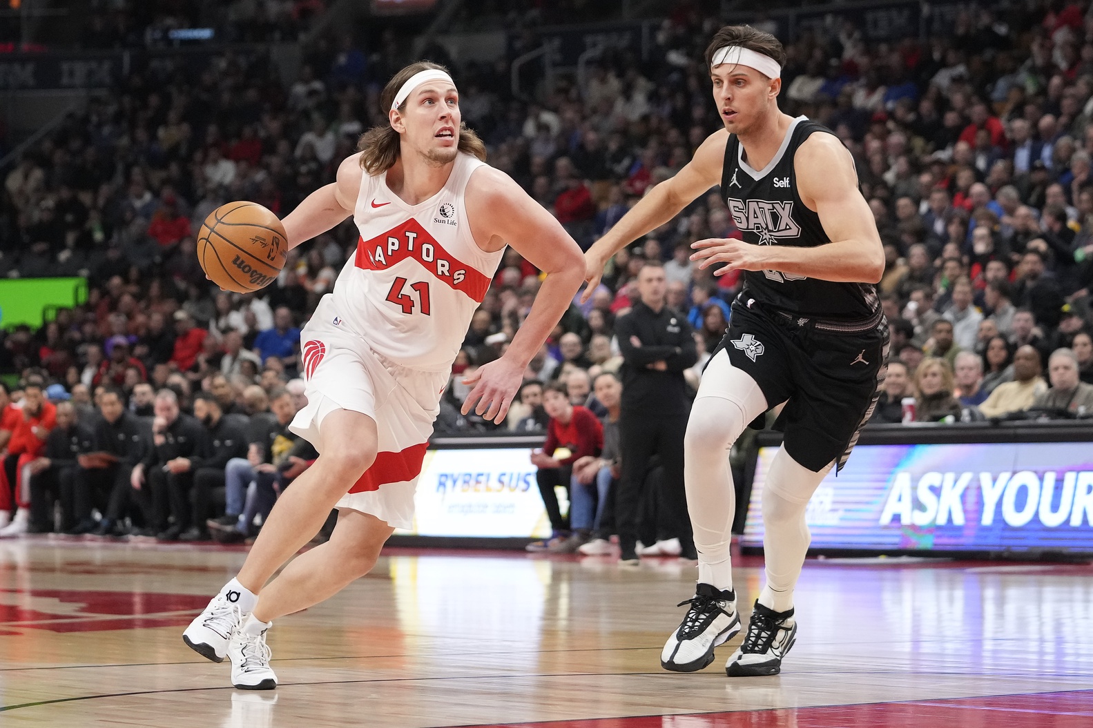 Feb 12, 2024; Toronto, Ontario, CAN; Toronto Raptors forward Kelly Olynyk (41) drives to the net against San Antonio Spurs forward Zach Collins (23) during the first half at Scotiabank Arena. Mandatory Credit: John E. Sokolowski-USA TODAY Sports