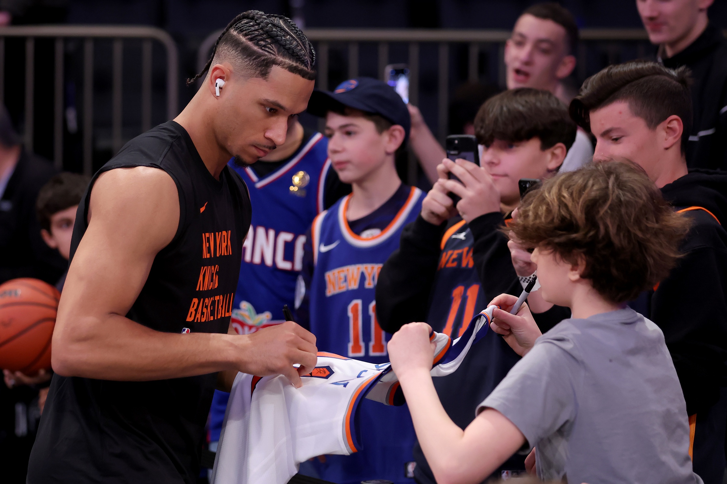 Mar 10, 2024; New York, New York, USA; New York Knicks guard Josh Hart (3) signs autographs for fans before a game against the Philadelphia 76ers at Madison Square Garden. Mandatory Credit: Brad Penner-USA TODAY Sports
