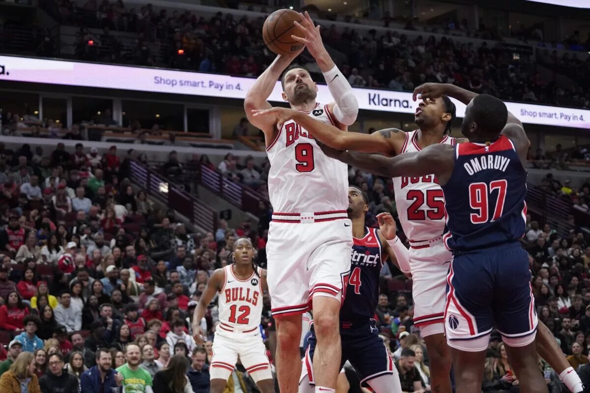 Washington Wizards forward Eugene Omoruyi (97) defends Chicago Bulls center Nikola Vucevic (9) during the second half at United Center.