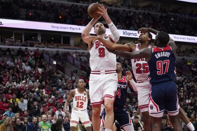 Washington Wizards forward Eugene Omoruyi (97) defends Chicago Bulls center Nikola Vucevic (9) during the second half at United Center.