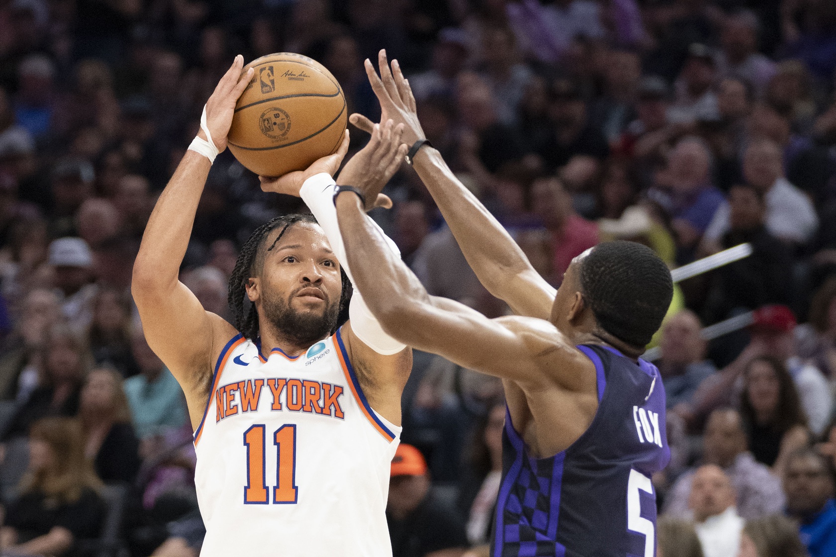 New York Knicks guard Jalen Brunson (11) shoots the basketball against Sacramento Kings guard De'Aaron Fox (5) during the second quarter at Golden 1 Center.