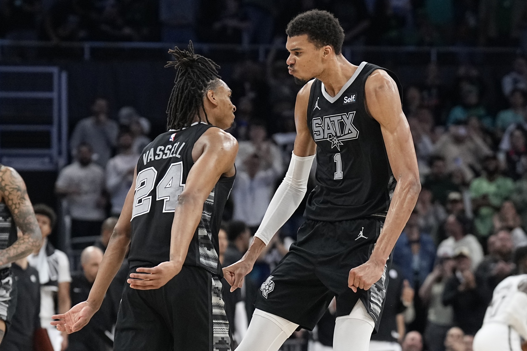 San Antonio Spurs forward Victor Wembanyama (1) and guard Devin Vassell (24) react during overtime against the Brooklyn Nets at Moody Center.
