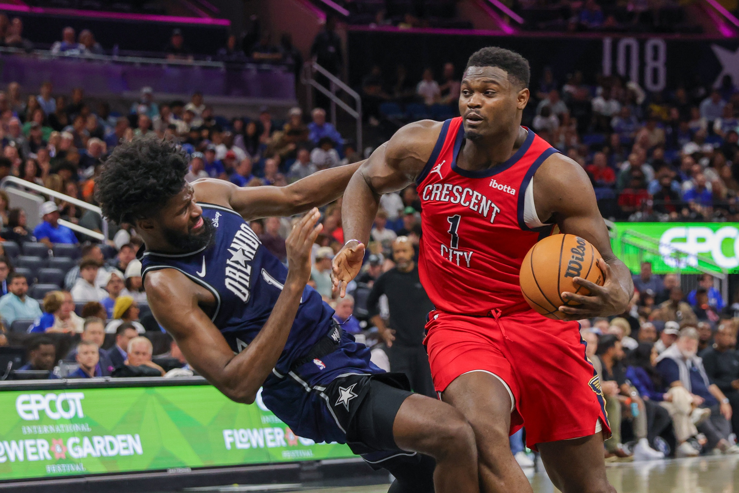 New Orleans Pelicans forward Zion Williamson (1) is fouled by Orlando Magic forward Jonathan Isaac (1) during the second half at KIA Center.