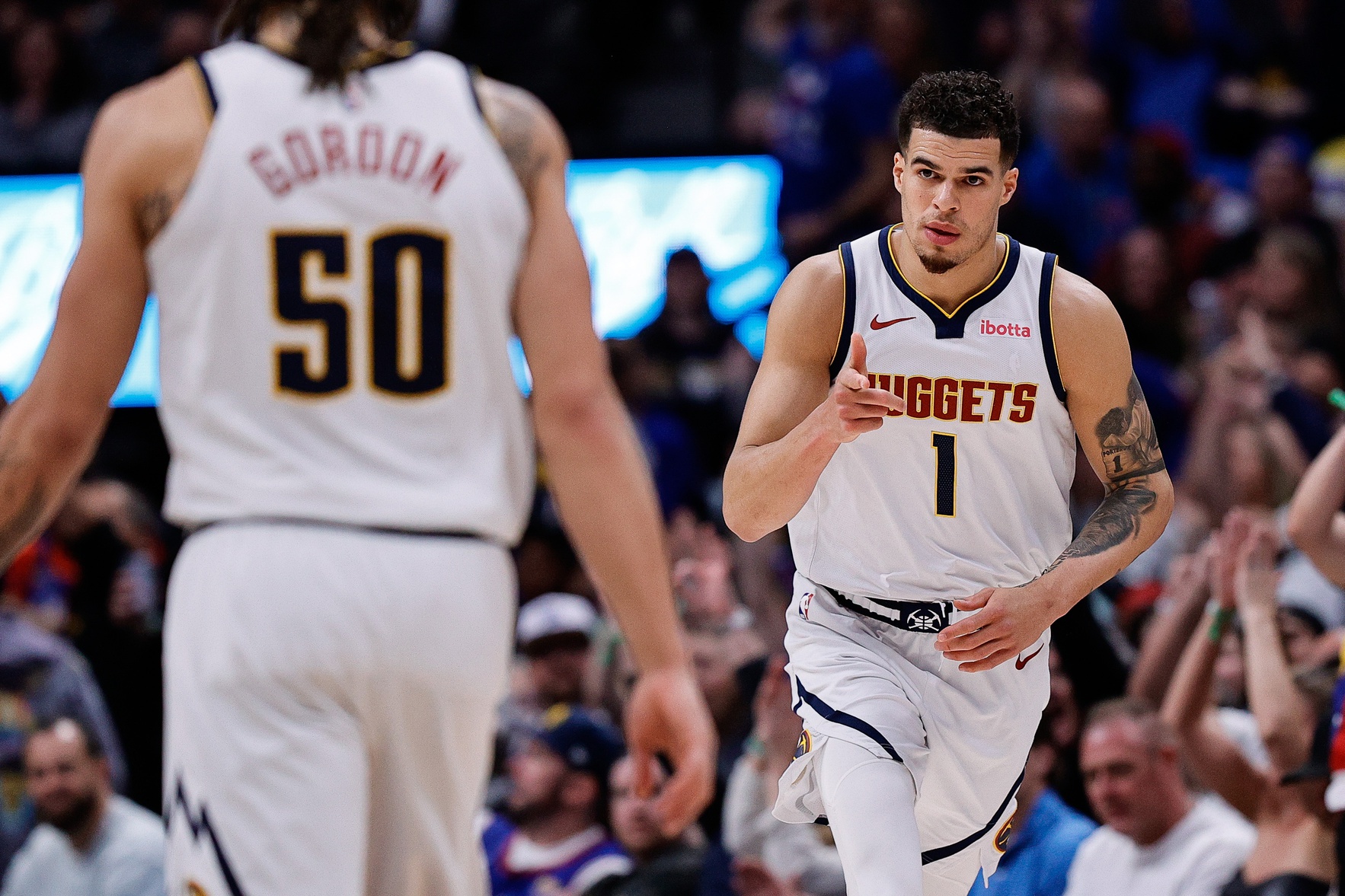Denver Nuggets forward Michael Porter Jr. (1) gestures to forward Aaron Gordon (50) after a basket in the fourth quarter against the New York Knicks at Ball Arena.