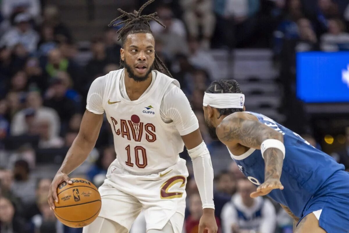 Cleveland Cavaliers guard Darius Garland (10) dribbles the ball and looks to pass over Minnesota Timberwolves guard Nickeil Alexander-Walker (9) in the first half at Target Center.