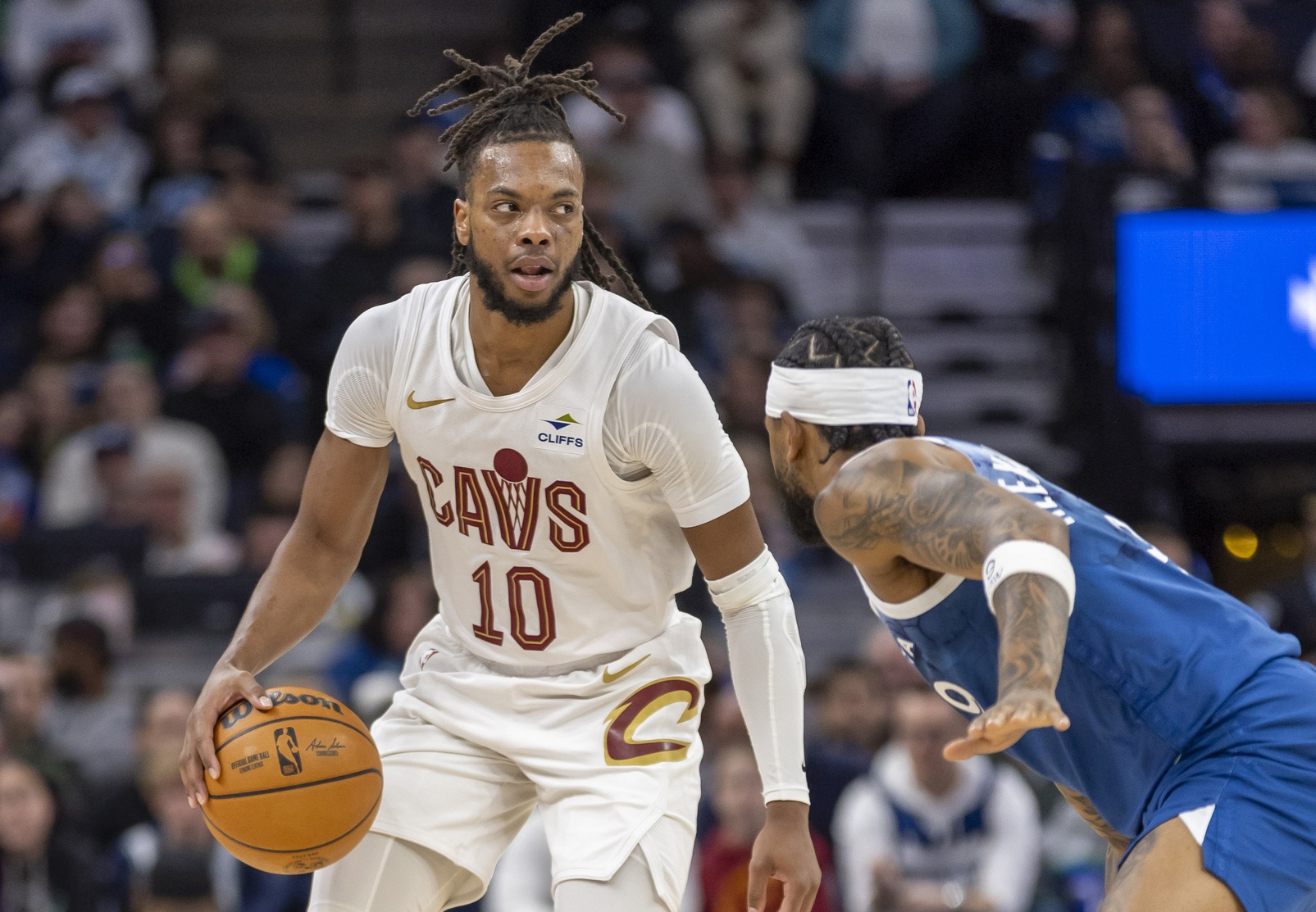 Cleveland Cavaliers guard Darius Garland (10) dribbles the ball and looks to pass over Minnesota Timberwolves guard Nickeil Alexander-Walker (9) in the first half at Target Center.