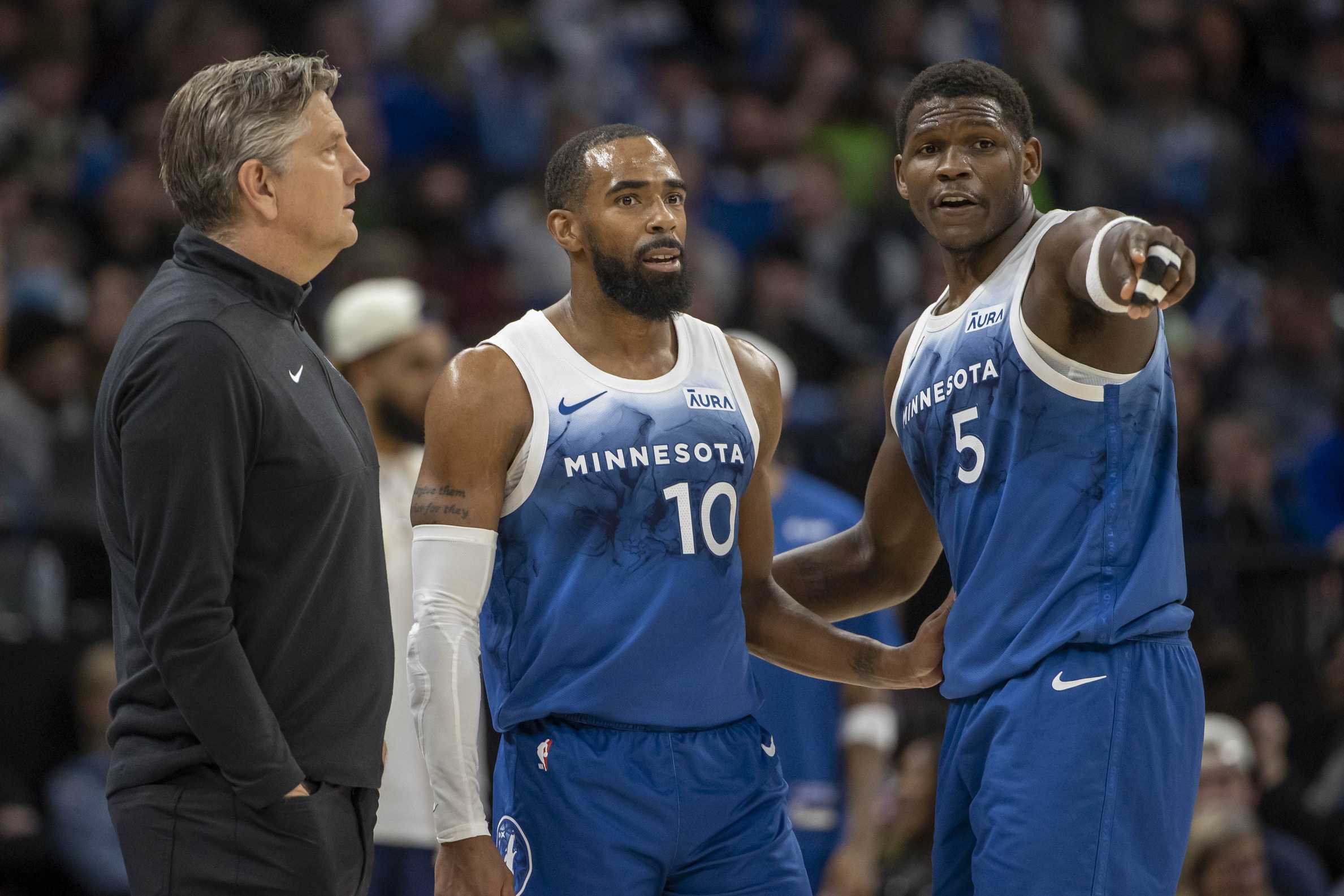 Minnesota Timberwolves head coach Chris Finch, guard Mike Conley (10), guard Anthony Edwards (5) huddle against the Cleveland Cavaliers in the second half at Target Center.