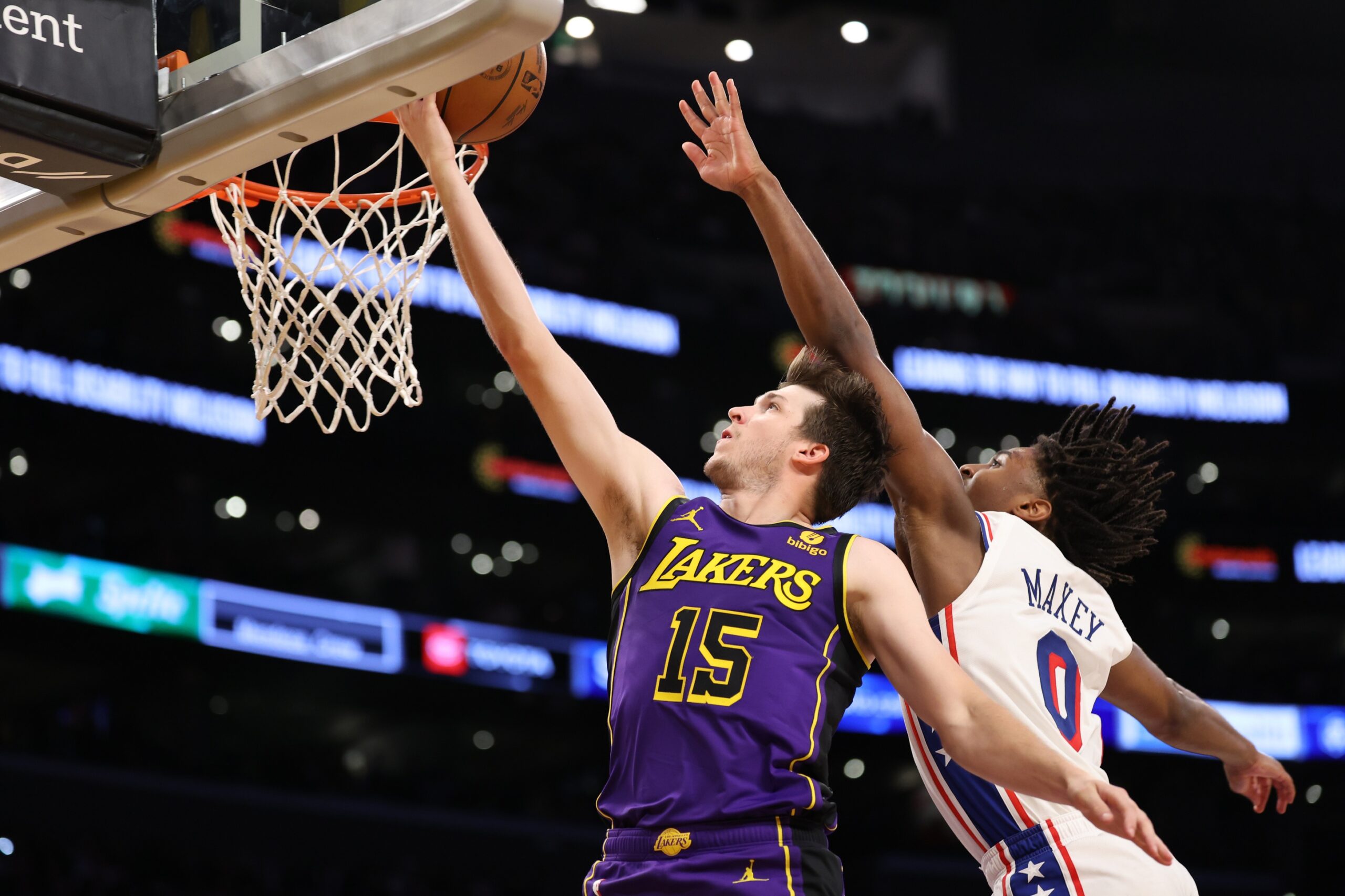 Mar 22, 2024; Los Angeles, California, USA; Los Angeles Lakers guard Austin Reaves (15) goes to the basket against Philadelphia 76ers guard Tyrese Maxey (0) during the fourth quarter at Crypto.com Arena. Mandatory Credit: Kiyoshi Mio-USA TODAY Sports