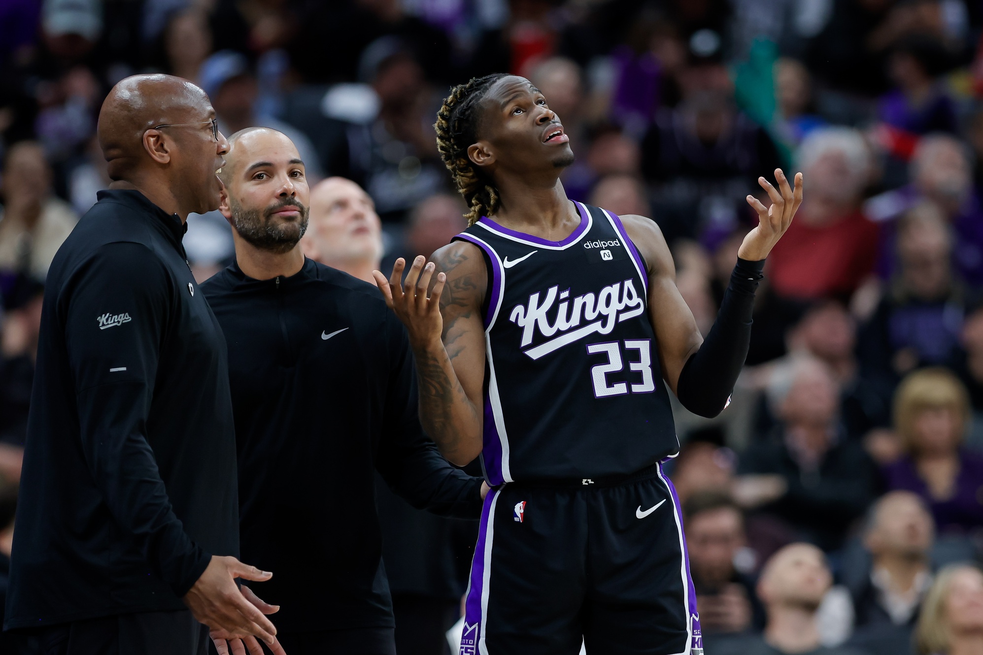 Sacramento Kings guard Keon Ellis (23) reviews a call with head coach Mike Brown during the second quarter against the Philadelphia 76ers at Golden 1 Center.