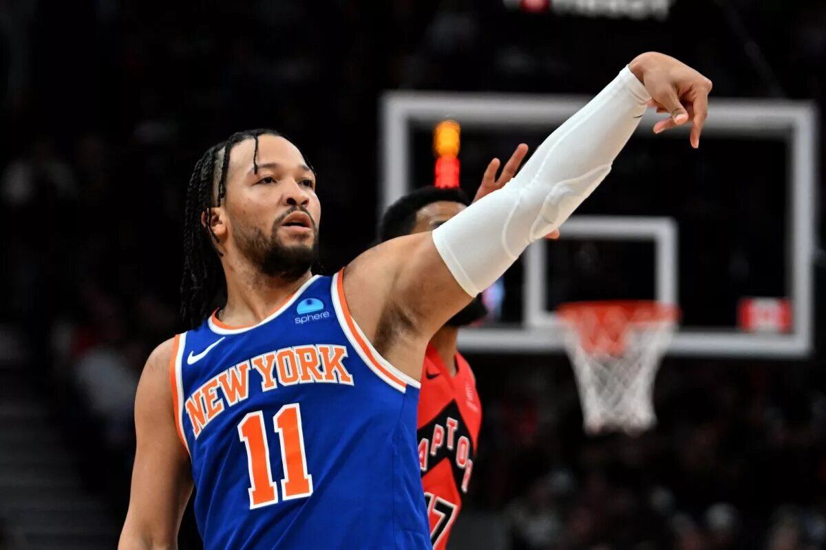 New York Knicks guard Jalen Brunson (11) follows through on a shot against the Toronto Raptors in the first half at Scotiabank Arena.