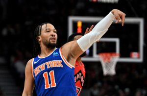New York Knicks guard Jalen Brunson (11) follows through on a shot against the Toronto Raptors in the first half at Scotiabank Arena.