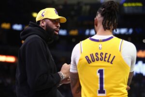 Mar 27, 2024; Memphis, Tennessee, USA; Los Angeles Lakers forward Anthony Davis (left) talks with guard D'Angelo Russell (1) during a time out during the second half against the Memphis Grizzlies at FedExForum. Mandatory Credit: Petre Thomas-USA TODAY Sports