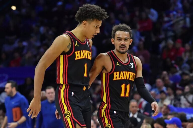 Atlanta Hawks guard Trae Young walks with rising star Jalen Johnson
