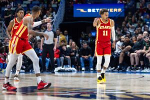 Atlanta Hawks guards Dejounte Murray and Trae Young point at one another