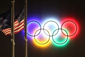 Olympics Rings beside USA flag ahead of 2024 Paris Olympics