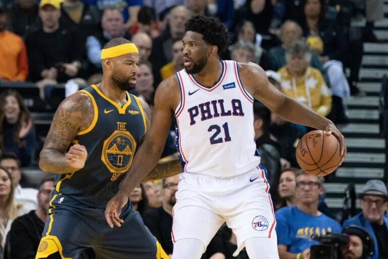 Former NBA star DeMarcus Cousins guards Philadelphia 76ers MVP Joel Embiid