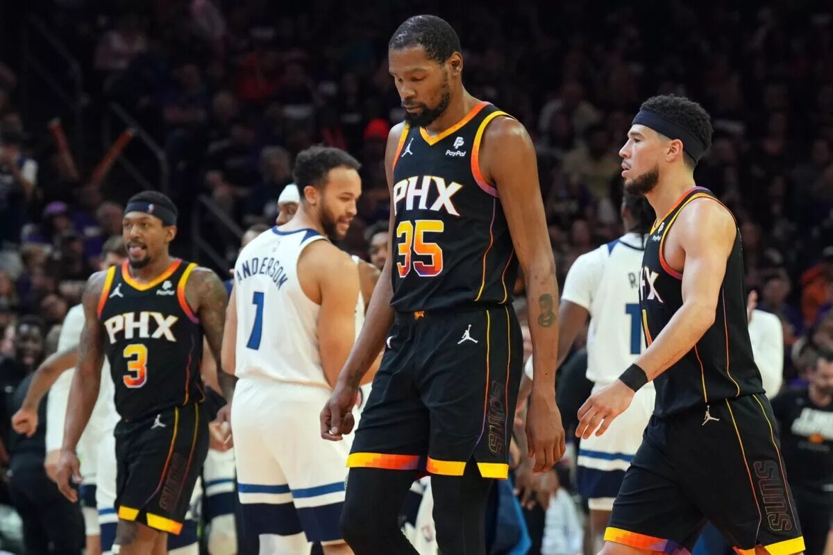 Phoenix Suns superstar Kevin Durant surrounded by teammates