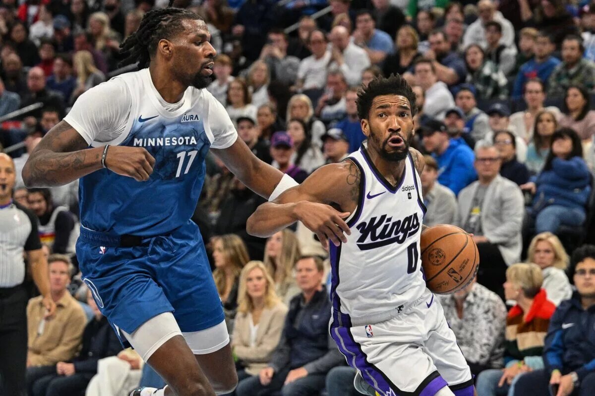 Nov 24, 2023; Minneapolis, Minnesota, USA; Sacramento Kings guard Malik Monk (0) goes to the basket as Minnesota Timberwolves center Naz Reid (11) defends during the game at Target Center. Mandatory Credit: Jeffrey Becker-USA TODAY Sports