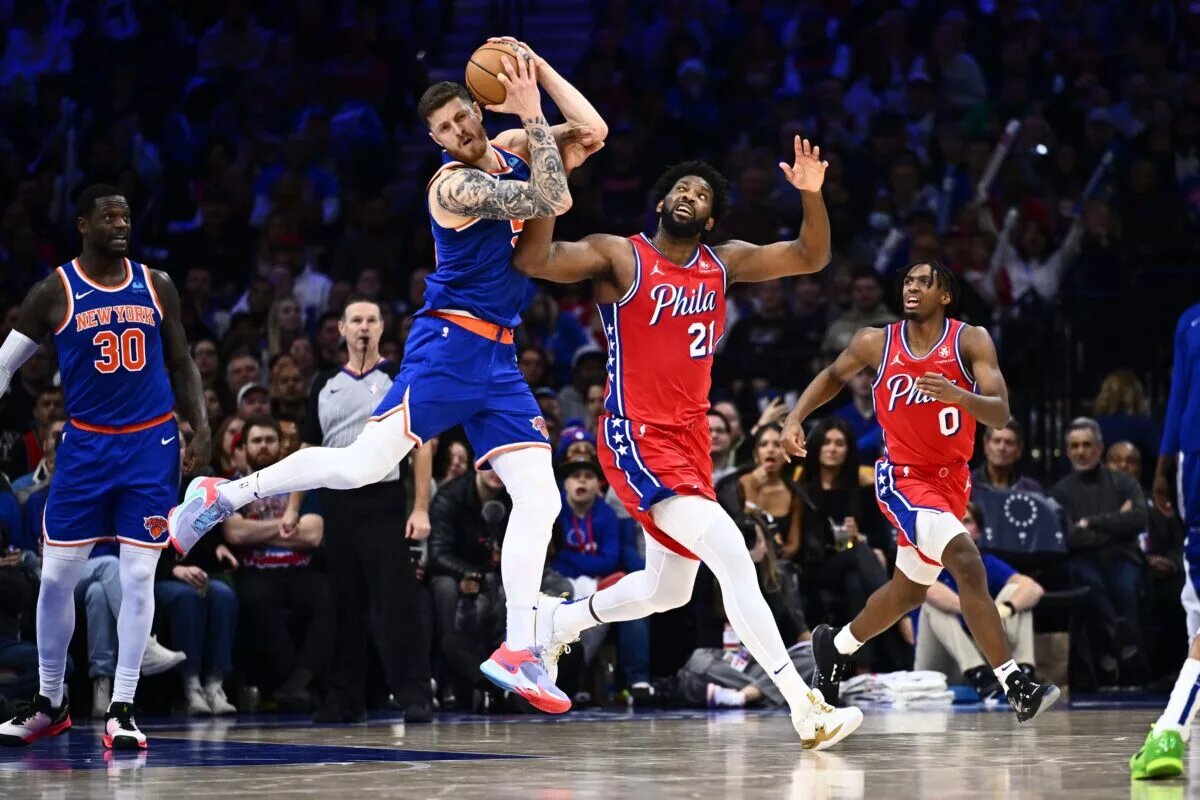Jan 5, 2024; Philadelphia, Pennsylvania, USA; New York Knicks center Isaiah Hartenstein (55) and Philadelphia 76ers center Joel Embiid (21) battle for the ball in the third quarter at Wells Fargo Center. Mandatory Credit: Kyle Ross-USA TODAY Sports