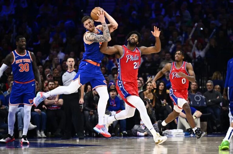 Jan 5, 2024; Philadelphia, Pennsylvania, USA; New York Knicks center Isaiah Hartenstein (55) and Philadelphia 76ers center Joel Embiid (21) battle for the ball in the third quarter at Wells Fargo Center. Mandatory Credit: Kyle Ross-USA TODAY Sports