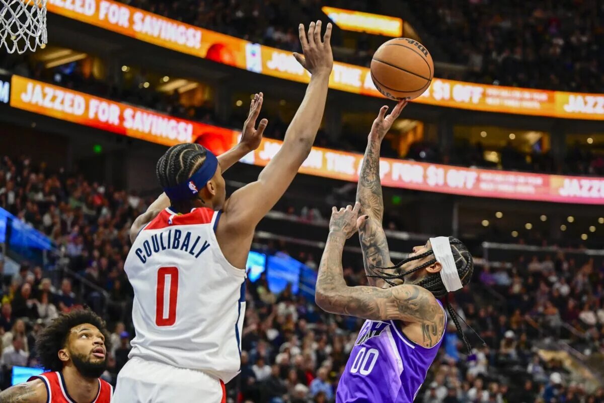 Mar 4, 2024; Salt Lake City, Utah, USA; Utah Jazz guard Jordan Clarkson (00) takes a shot over Washington Wizards guard Bilal Coulibaly (0) during the second half at the Delta Center. Mandatory Credit: Christopher Creveling-USA TODAY Sports